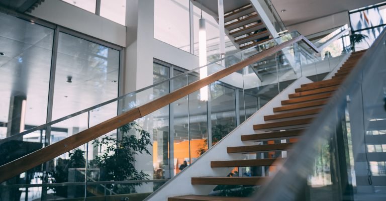 Modern room with a wooden staircase during daytime A modern room with a wooden staircase during daytime